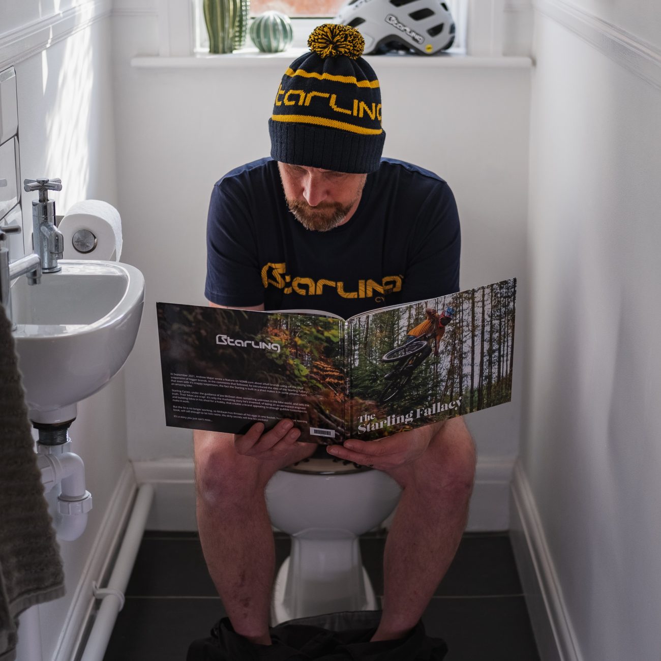 John reading Starling Fallacy on the toilet