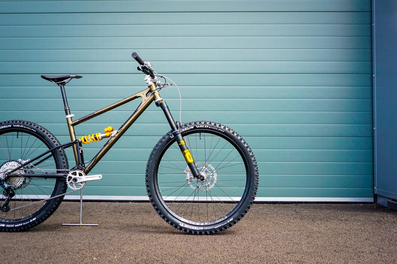 Starling Cycles bike against blue roller shutter door