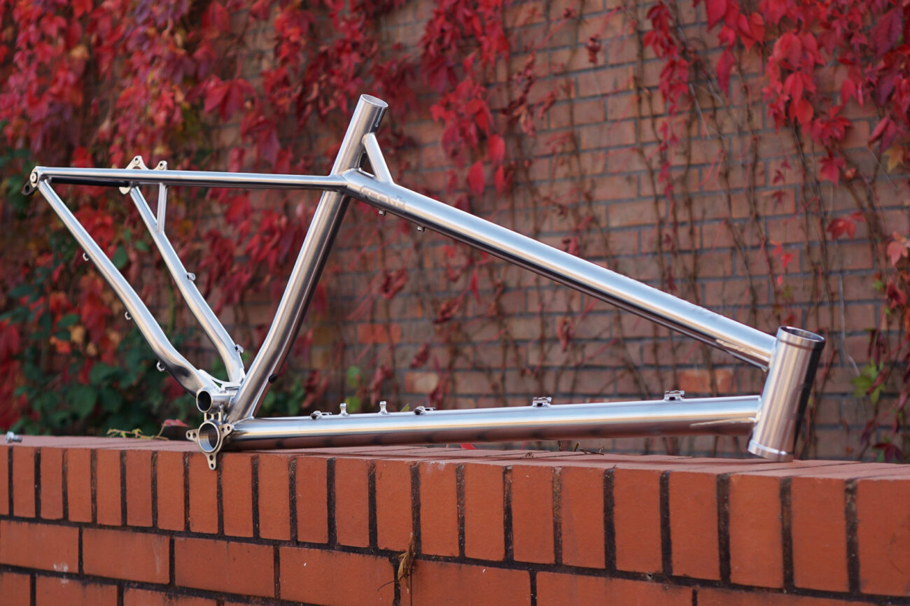 Starling Cycles Roost Frame on a wall with red ivy in the background