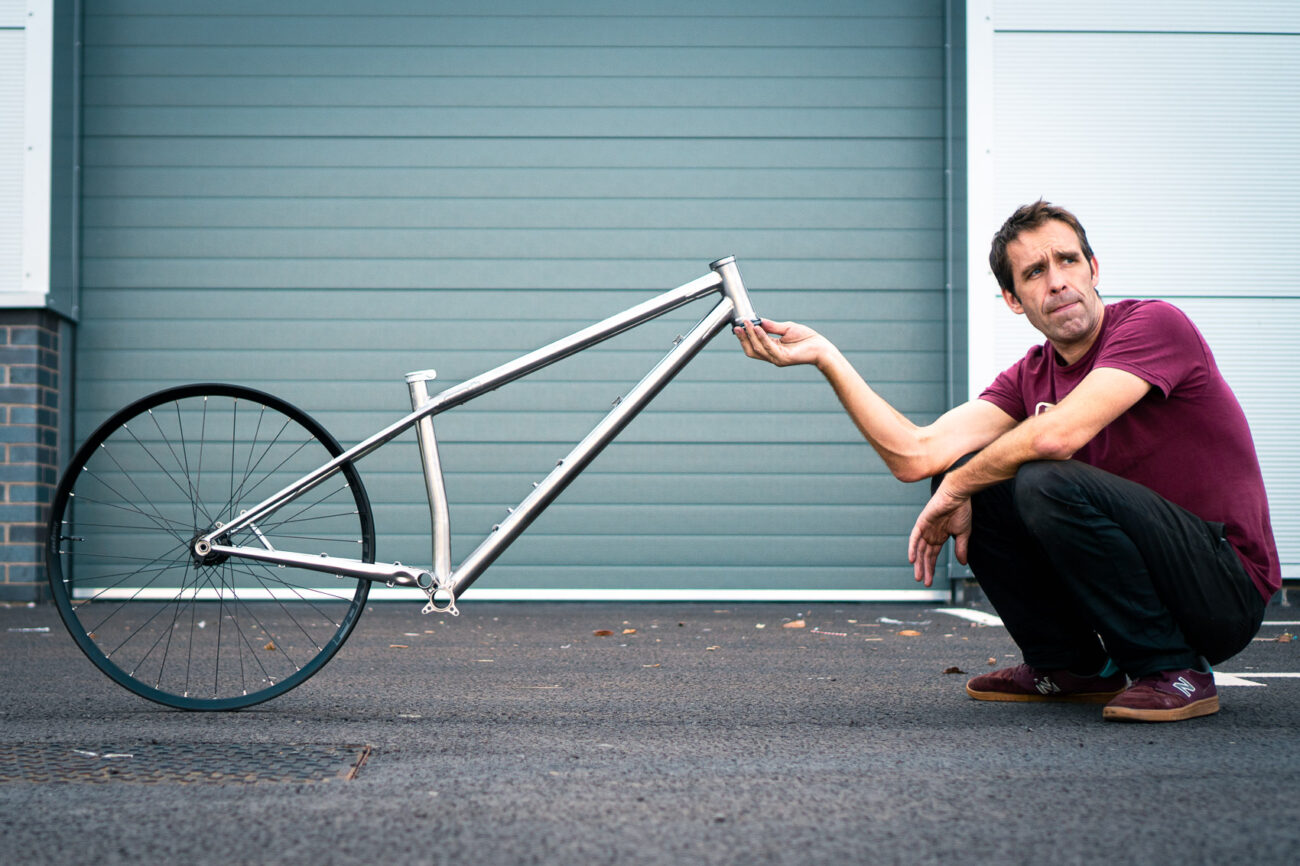 Starling Roost Frame and rear wheel with Joe McEwan holding frame