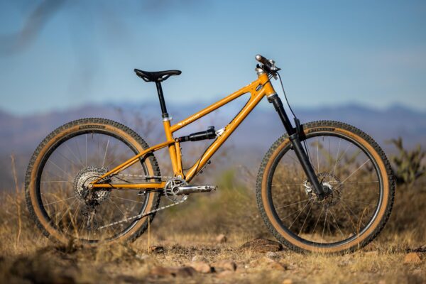 an orange mountain bike in a desert landscape