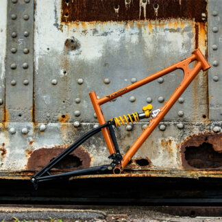 a starling swoop mountain bike balanced on a piece of rusty machinery