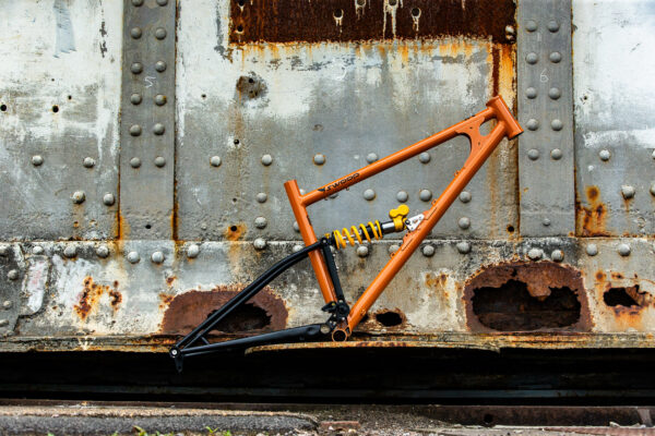 a starling swoop mountain bike balanced on a piece of rusty machinery