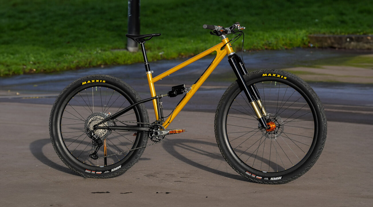 yellow full suspension Starling mountain bike in urban setting
