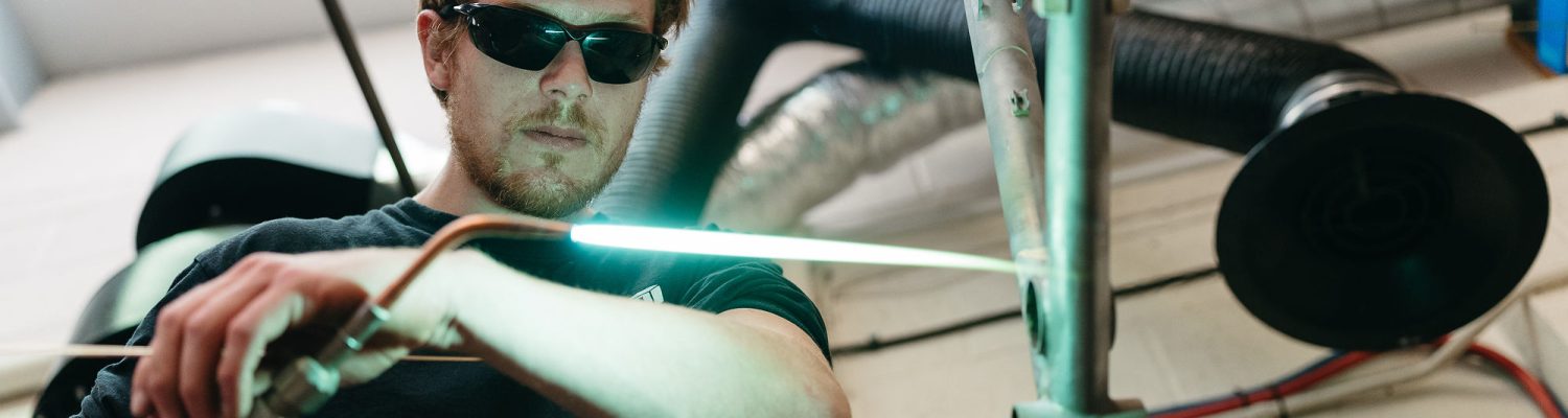 a man welding a frame in the starling workshop